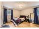 Cozy bedroom with wood floors, plush bedding, natural light, and closet at 8640 Embrey Dr, Jonesboro, GA 30236
