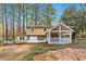 Charming two-story home with stone accents, covered porch, and a well-maintained front yard at 8640 Embrey Dr, Jonesboro, GA 30236