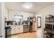 Kitchen area with stainless steel appliances, white cabinets, and laminate flooring at 8640 Embrey Dr, Jonesboro, GA 30236