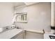 This laundry room features natural light and functional appliances at 8640 Embrey Dr, Jonesboro, GA 30236