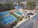 Aerial view of the tennis courts, lake, clubhouse, and playground at 2837 Captain Ct, Dacula, GA 30019