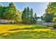 The backyard features a lush green lawn with tall trees and mature landscaping along the fence line at 2837 Captain Ct, Dacula, GA 30019