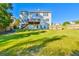 A wide, open backyard features a lush green lawn and a wooden fence around the perimeter of the property at 2837 Captain Ct, Dacula, GA 30019
