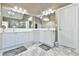 Bright bathroom with double sink vanity, large mirror, and updated fixtures, offering a clean design at 2837 Captain Ct, Dacula, GA 30019