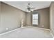 Neutral bedroom with ceiling fan, a light-filled window and plush carpet creating a serene atmosphere at 2837 Captain Ct, Dacula, GA 30019