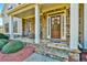 Charming front porch with stone accents, inviting entrance and seating area at 2837 Captain Ct, Dacula, GA 30019