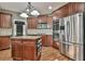 Kitchen with stainless appliances, island, and hardwood floors at 2837 Captain Ct, Dacula, GA 30019