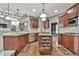Open kitchen with stainless appliances, island, and hardwood flooring at 2837 Captain Ct, Dacula, GA 30019