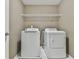 Functional laundry area equipped with modern washer and dryer and an overhead storage shelf at 2837 Captain Ct, Dacula, GA 30019