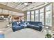Open-concept living area with large windows, coffered ceiling, and seamless kitchen access at 2837 Captain Ct, Dacula, GA 30019