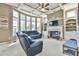 Bright living room features a fireplace, built-in shelves, and large windows at 2837 Captain Ct, Dacula, GA 30019
