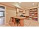 A bright office features custom built-in shelves, cabinets, and a large desk, illuminated by recessed lighting at 2837 Captain Ct, Dacula, GA 30019