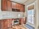 Cozy office nook with granite counters, cherry cabinets, and view of backyard at 2837 Captain Ct, Dacula, GA 30019