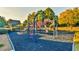 Community playground with colorful play structures and a soft, resilient ground surface at 2837 Captain Ct, Dacula, GA 30019