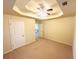 Bright bedroom with a tray ceiling, ceiling fan, and neutral carpeting at 3309 Gardenside Walk, Loganville, GA 30052