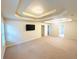 Large bedroom featuring neutral walls and carpet with a tray ceiling at 3309 Gardenside Walk, Loganville, GA 30052