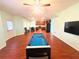 Wide angle view of the game room including a pool table, kitchen and a table with chairs at 3309 Gardenside Walk, Loganville, GA 30052