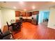 Modern kitchen with wooden cabinets, stainless steel appliances, table and laminated wood flooring at 3309 Gardenside Walk, Loganville, GA 30052