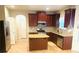 Well-equipped kitchen featuring stainless steel appliances, granite countertops, an island, and plenty of cabinet space at 3309 Gardenside Walk, Loganville, GA 30052