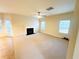 Spacious living room featuring a fireplace, ceiling fan, and multiple windows offering abundant natural light at 3309 Gardenside Walk, Loganville, GA 30052