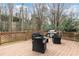 Outdoor deck area with comfortable seating, a grill, and wooded views at 5170 Deerlake Dr, Alpharetta, GA 30005