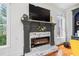 Close-up of the fireplace with decorative mantel, stone surround, and large windows at 5170 Deerlake Dr, Alpharetta, GA 30005