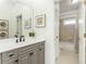 Bathroom with a gray vanity, tub and shower with neutral tile at 1399 Legrand Cir, Lawrenceville, GA 30043