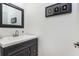 Contemporary half-bathroom with custom vanity, modern fixtures, and decorative mirror at 1399 Legrand Cir, Lawrenceville, GA 30043