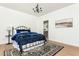 Bedroom with a black metal bed frame, blue bedding, and wood flooring at 1399 Legrand Cir, Lawrenceville, GA 30043