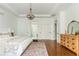 Spacious bedroom featuring hardwood floors, white walls, and a walk through to a bathroom with matching white doors at 1399 Legrand Cir, Lawrenceville, GA 30043