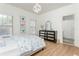 Bedroom with a floral pattern bedspread, wood floors, and bathroom entrance at 1399 Legrand Cir, Lawrenceville, GA 30043