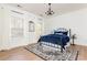 Bedroom with a black metal bed frame, blue bedding, and wood flooring at 1399 Legrand Cir, Lawrenceville, GA 30043