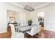 Bright dining room with hardwood floors, wainscoting, and a modern chandelier at 1399 Legrand Cir, Lawrenceville, GA 30043