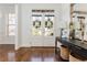 Light-filled foyer featuring hardwood floors, console table with decor and a decorative mirror at 1399 Legrand Cir, Lawrenceville, GA 30043