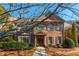 Charming brick two-story home with well-manicured landscaping and covered entryway at 1399 Legrand Cir, Lawrenceville, GA 30043