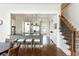 Open floor plan showcasing kitchen with island seating and stairs with patterned carpet runner at 1399 Legrand Cir, Lawrenceville, GA 30043