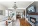 Open living area showcasing hardwood floors, fireplace, and view into the modern kitchen at 1399 Legrand Cir, Lawrenceville, GA 30043