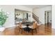 Open floor plan showcasing dining area, view of kitchen with island seating, and stairs with patterned carpet runner at 1399 Legrand Cir, Lawrenceville, GA 30043