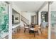 Open floor plan showcasing dining area, view of kitchen with island seating, and stairs with black wrought iron at 1399 Legrand Cir, Lawrenceville, GA 30043