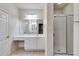 Bright bathroom featuring a shower, toilet, and vanity with a mirror and lighting at 1404 Haven Cir, Douglasville, GA 30135