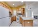 Cozy kitchen with wood cabinets, white appliances, and a view into the staged living room at 1404 Haven Cir, Douglasville, GA 30135