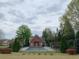 Exterior shot of a fenced-in pool surrounded by green trees and bushes at 1404 Haven Cir, Douglasville, GA 30135