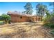 Rear view of home featuring brick facade and covered patio at 1465 Rockbridge Rd, Stone Mountain, GA 30087