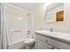 Bathroom with a tub, shower combo, tile flooring and white vanity at 1465 Rockbridge Rd, Stone Mountain, GA 30087