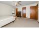 Bedroom featuring neutral carpet, ceiling fan, and traditional wood trim at 1465 Rockbridge Rd, Stone Mountain, GA 30087