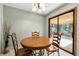 Dining area with wooden table and chairs next to sliding glass doors at 1465 Rockbridge Rd, Stone Mountain, GA 30087