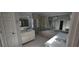 This bathroom has dual sinks, large mirrors, a shower, and a soaking tub at 3302 Fieldwood Se Dr, Smyrna, GA 30080