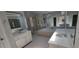 This spacious bathroom has dual sinks, large mirrors, a shower, and a soaking tub at 3302 Fieldwood Se Dr, Smyrna, GA 30080