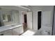This bathroom features dual sinks, large mirrors, a walk in closet and entry to a separate room at 3302 Fieldwood Se Dr, Smyrna, GA 30080