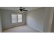 This cozy bedroom features neutral tones, a ceiling fan, and a window with plantation shutters at 3302 Fieldwood Se Dr, Smyrna, GA 30080